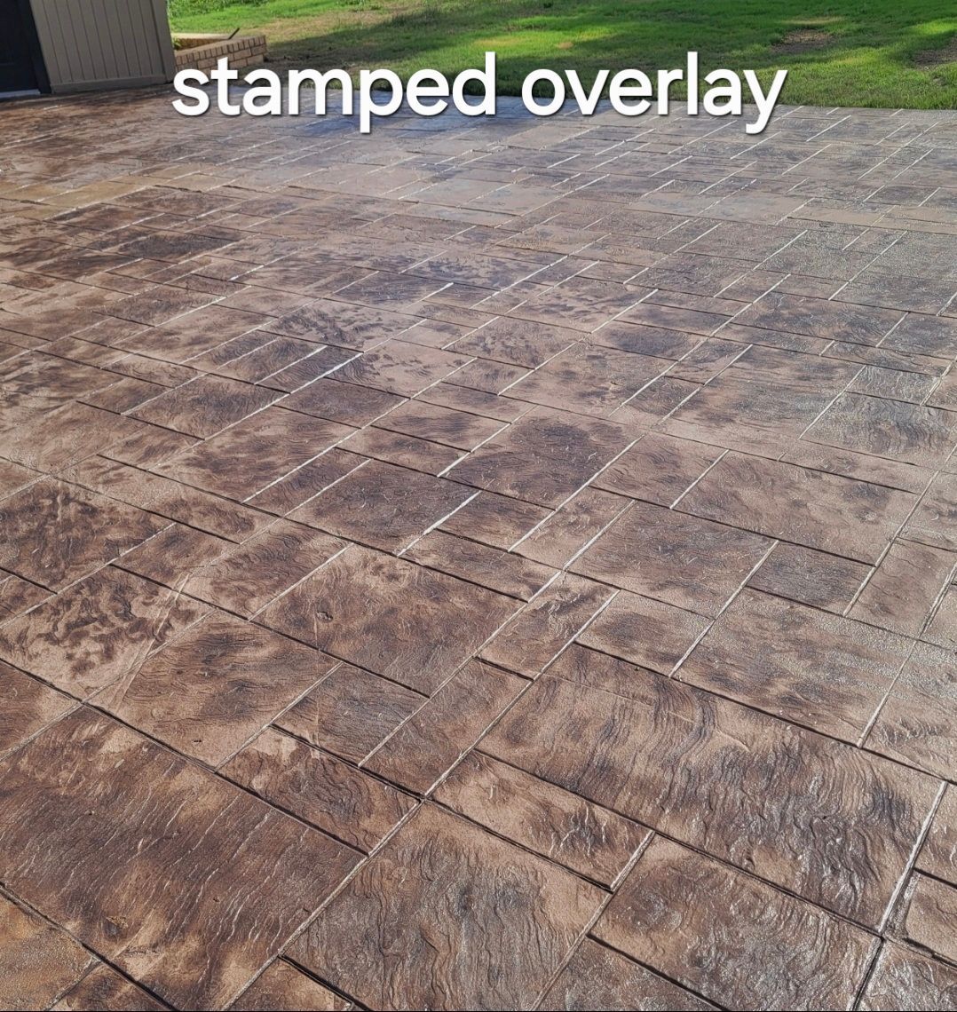 Stamped concrete patio with a stone-like square pattern in brown and gray tones