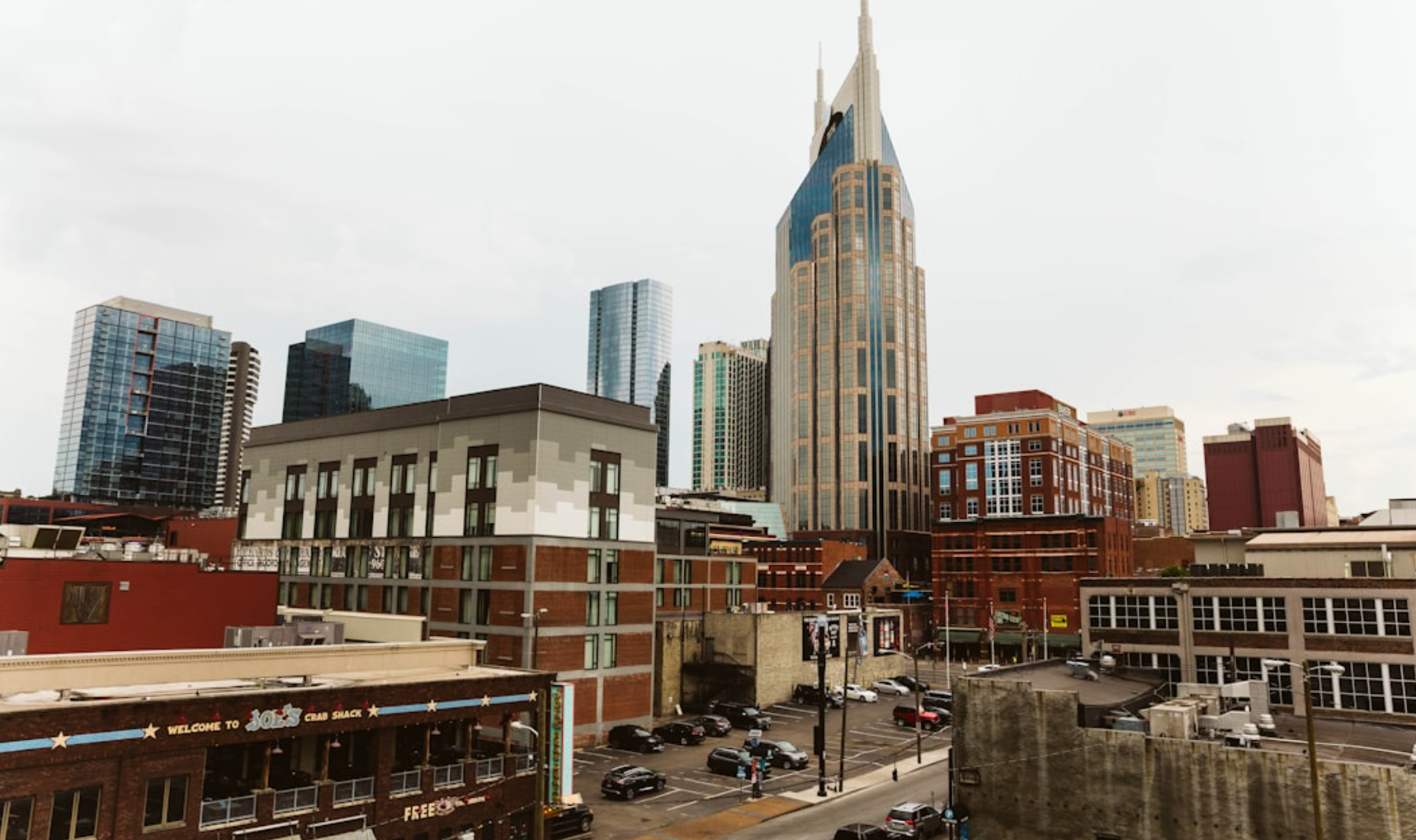 Nashville, Tennessee skyline with tall buildings, including the iconic AT&T building, on an overcast day.