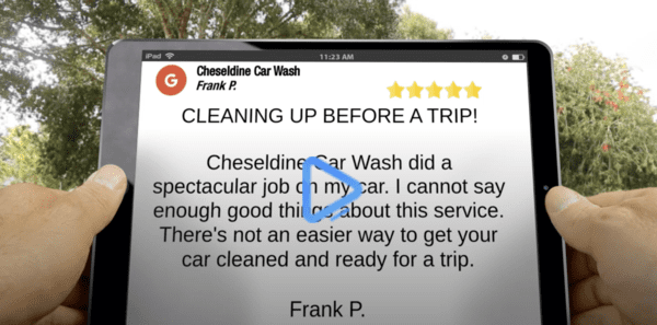 Person holding tablet showing a 5-star review for 