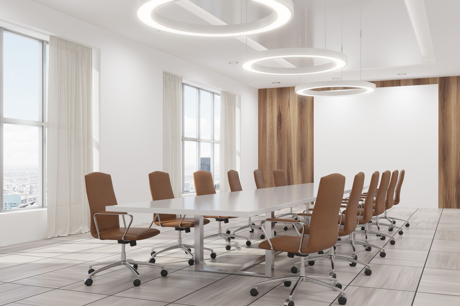 Bright modern conference room with a long table, rolling chairs, large windows, and circular ceiling lights