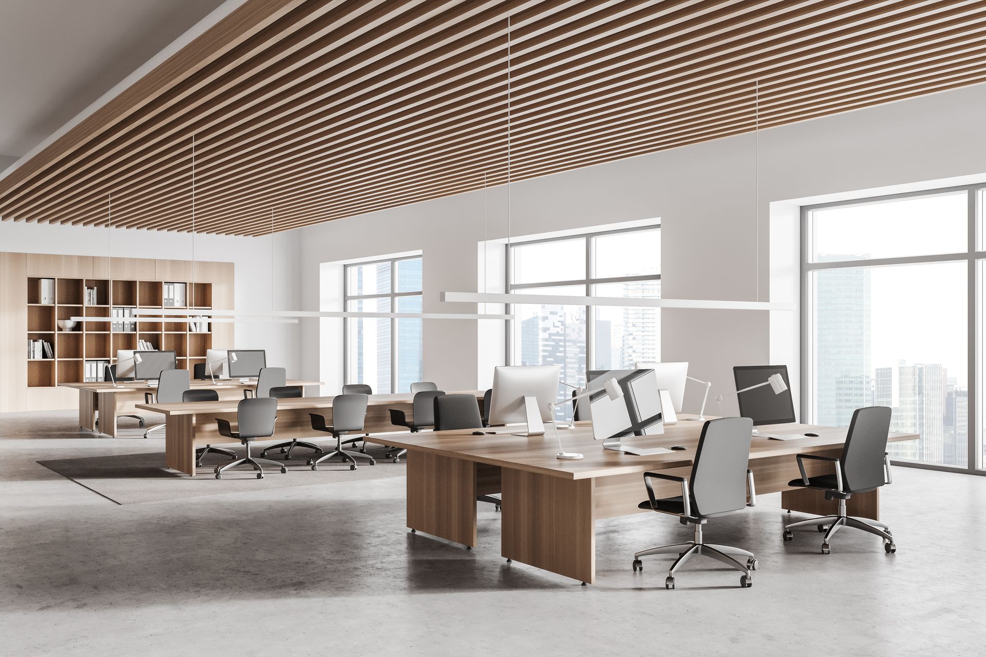 Modern open office with desks, chairs, computers, and a wavy wood ceiling in a bright workspace
