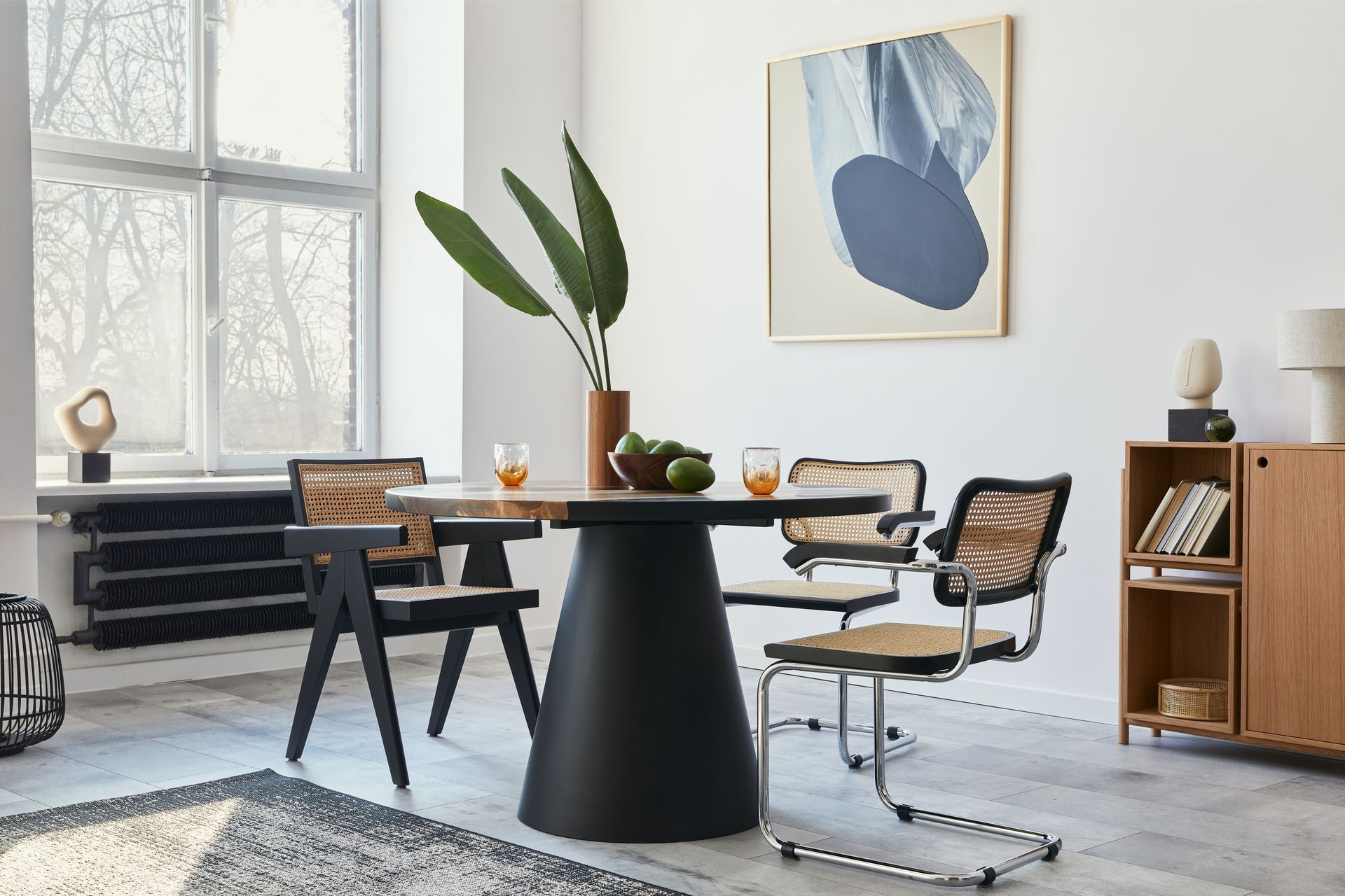 Modern glass-walled conference room with orange chairs in a bright office corridor