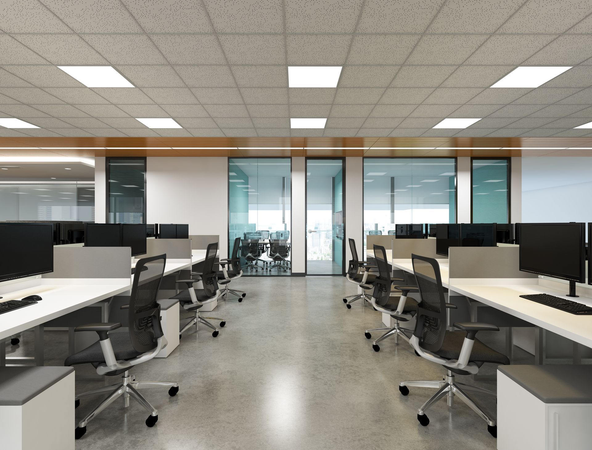 Modern open-plan office with rows of desks, black chairs, and large glass windows.
