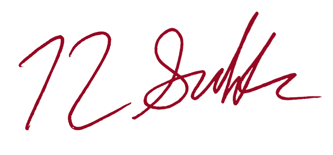 Red handwritten signature on a white background