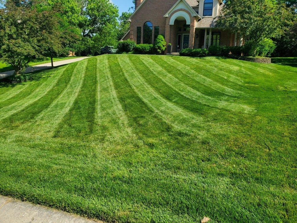 A lush green lawn with a lawn mower.