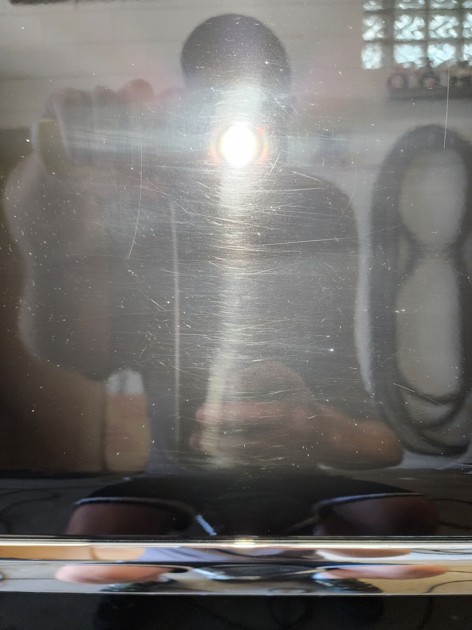 A person is taking a picture of themselves in a mirror.