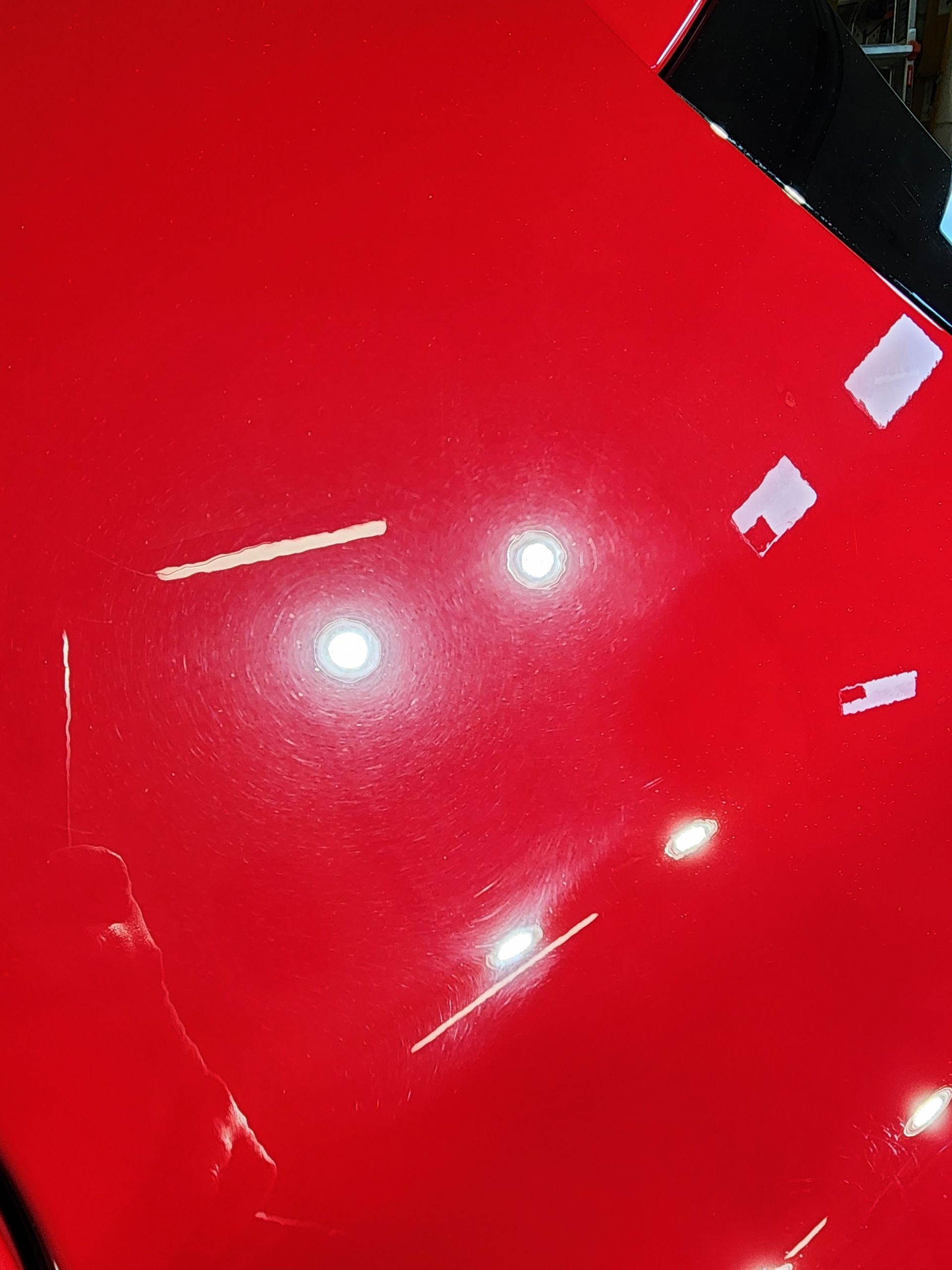 A close up of a red surface with a few white spots on it