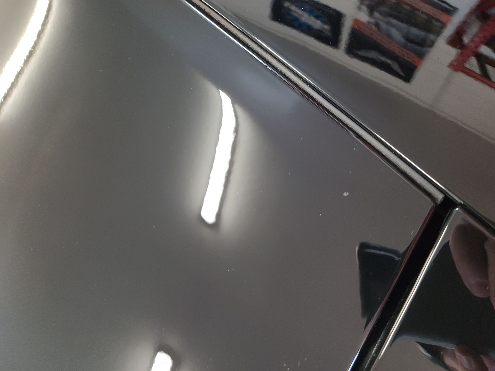 A mirror with a reflection of a car in it