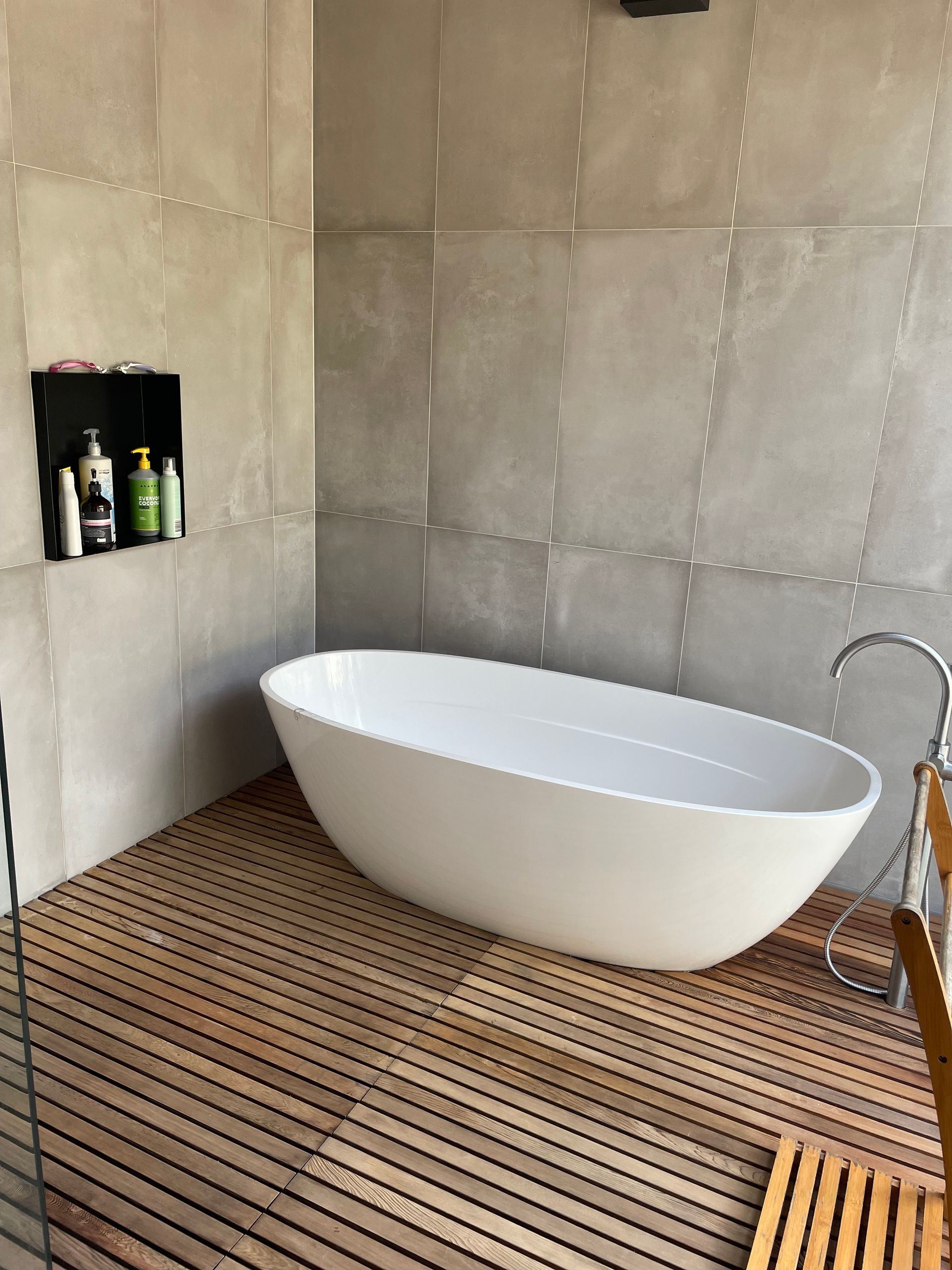 Modern Bathroom with White Tub, Sink, and Concrete Walls — On The Rise Builders in North Arm, QLD