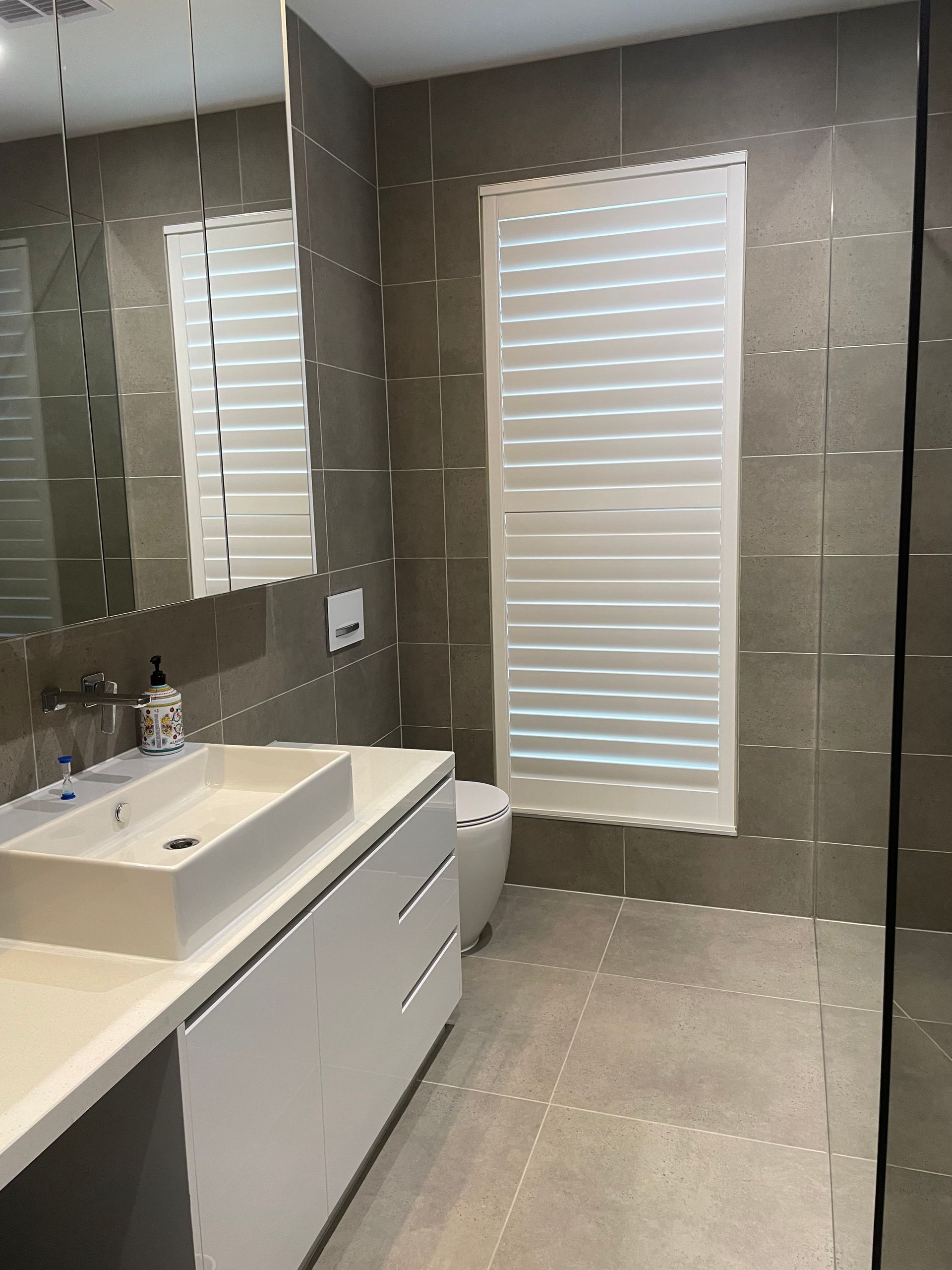 Modern Bathroom with White Fixtures, Neutral Walls — On The Rise Builders in North Arm, QLD