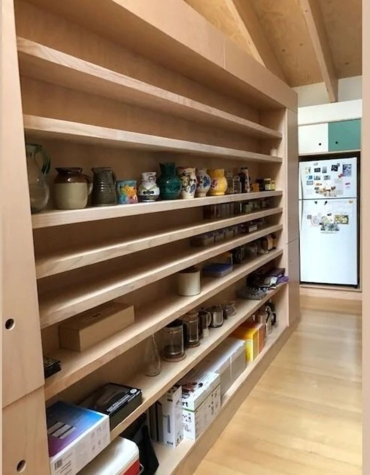 Built-In Wooden Shelves Holding Various Items in A Hallway — On The Rise Builders in North Arm, QLD