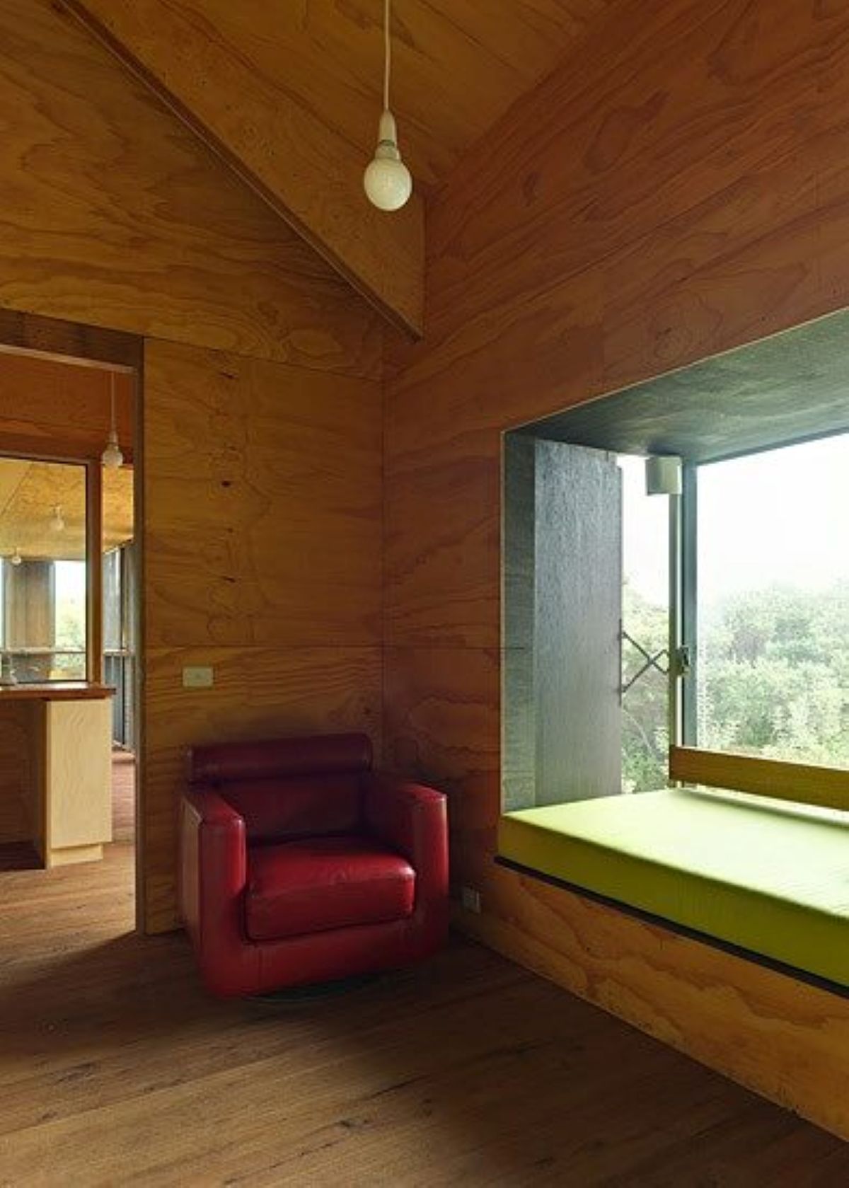 Interior with Red Chair, Wood Walls, and Window Seat — On The Rise Builders in Caloundra, QLD