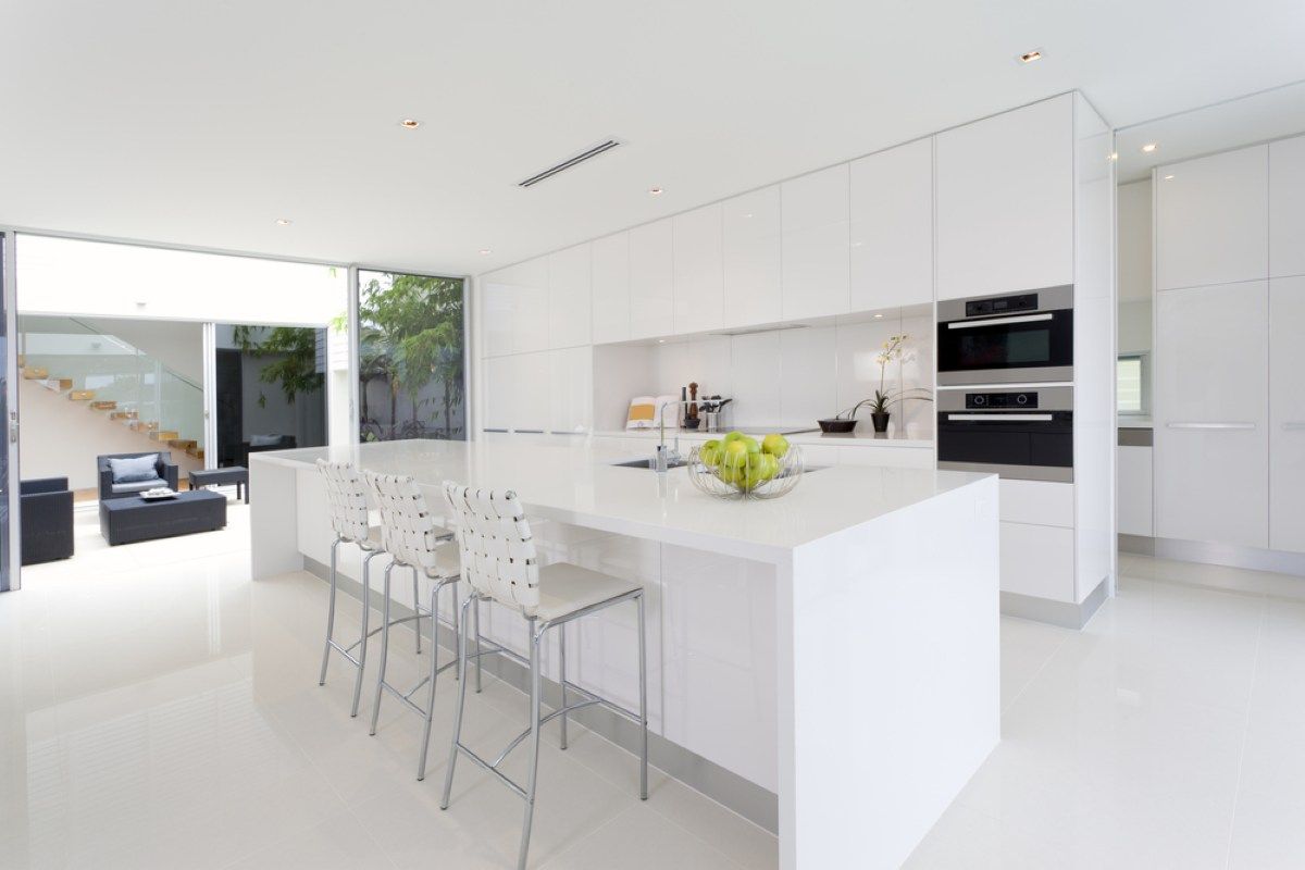 Modern All-White Kitchen with An Island, Chairs — On The Rise Builders in Coolum, QLD