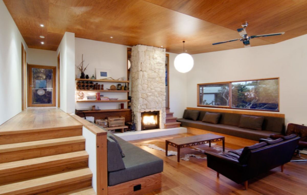 Wooden-Floored Living Room with Fireplace, Built-In Seating — On The Rise Builders in Coolum, QLD