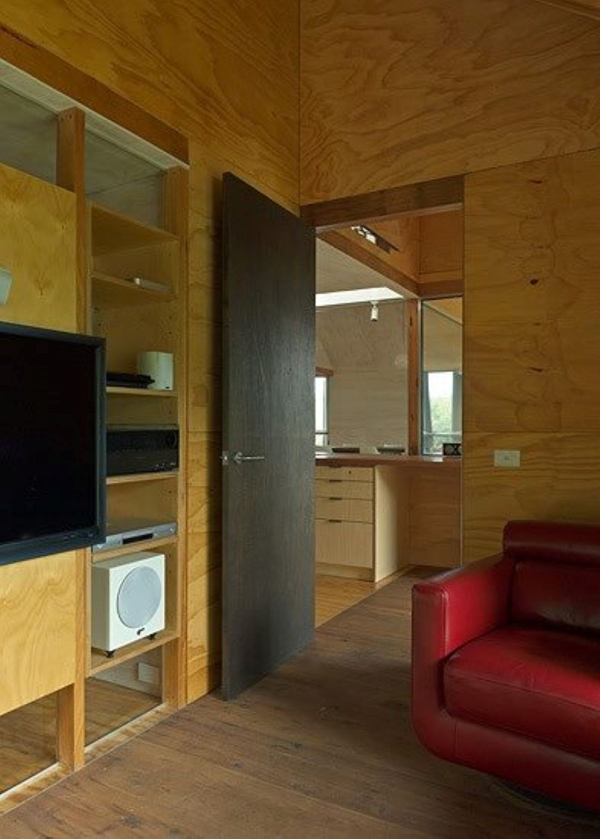 Wooden-Paneled Interior with A Red Leather Chair, TV — On The Rise Builders in Nambour, QLD