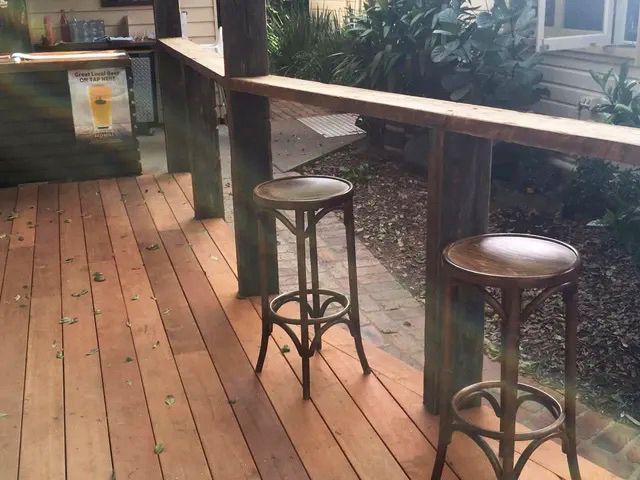 Wooden Deck with Two Bar Stools at An Outdoor Bar — On The Rise Builders in North Arm, QLD