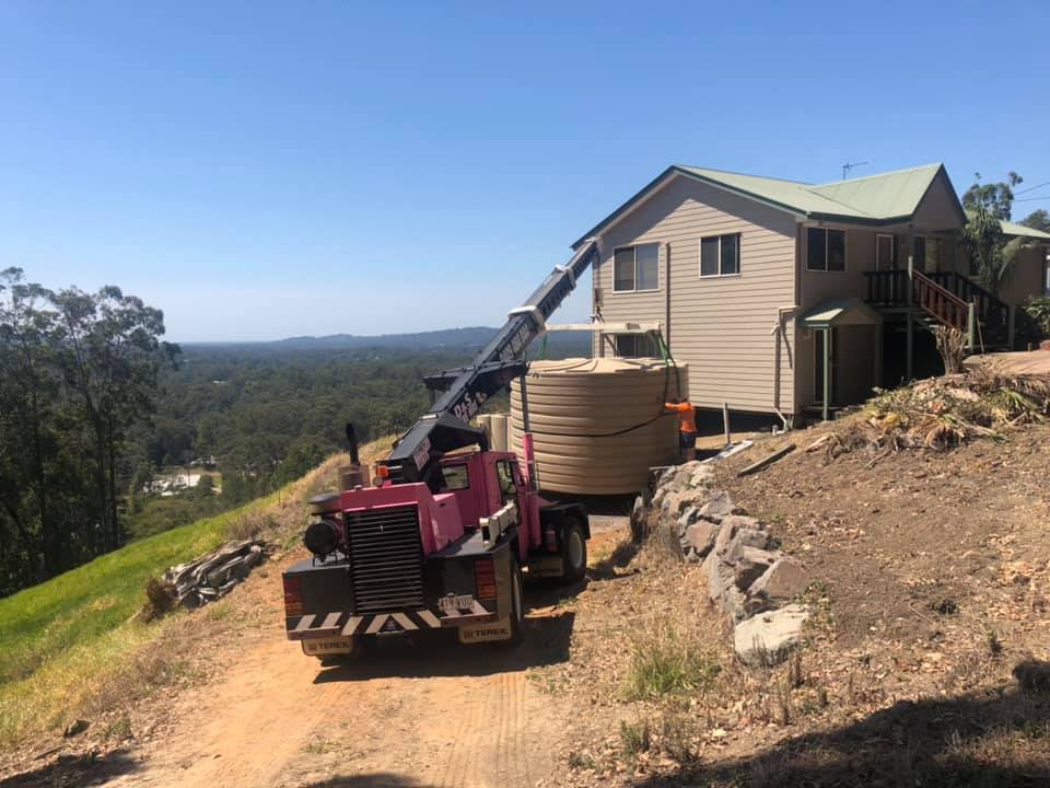 A Small Mobile Crane Installing a Water Tank at A Property —  D & S Crane Hire & Rigging In Kunda Park, QLDCoast