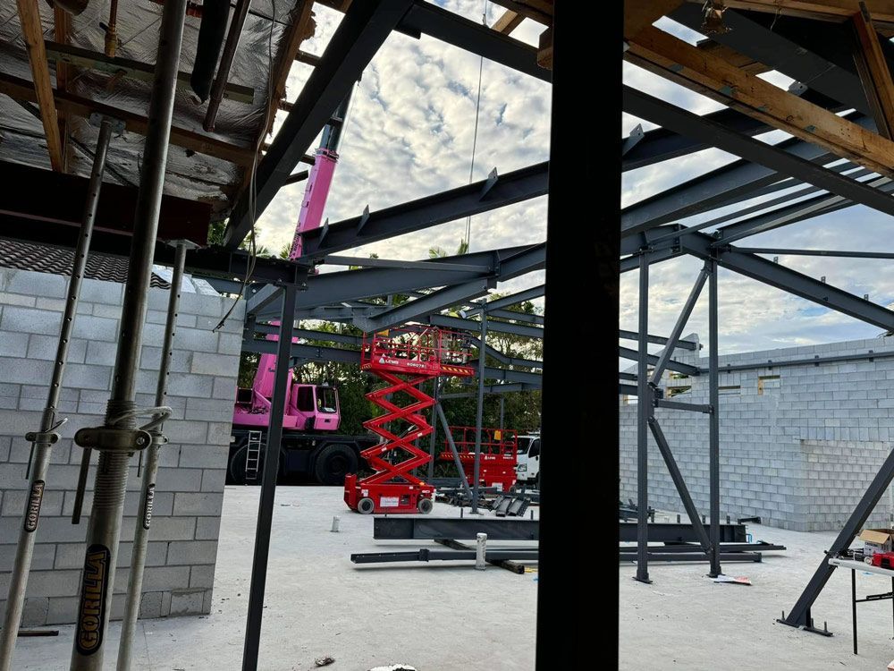 A Red Scissor Lifts And A Pink Crane