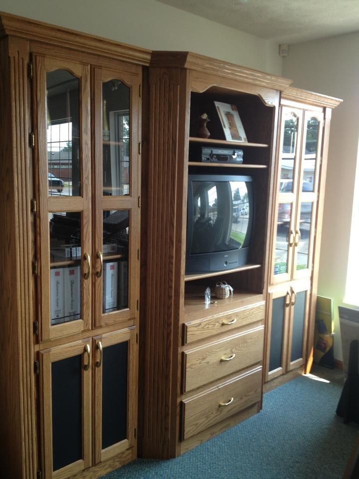 A living room with a tv and lots of cabinets