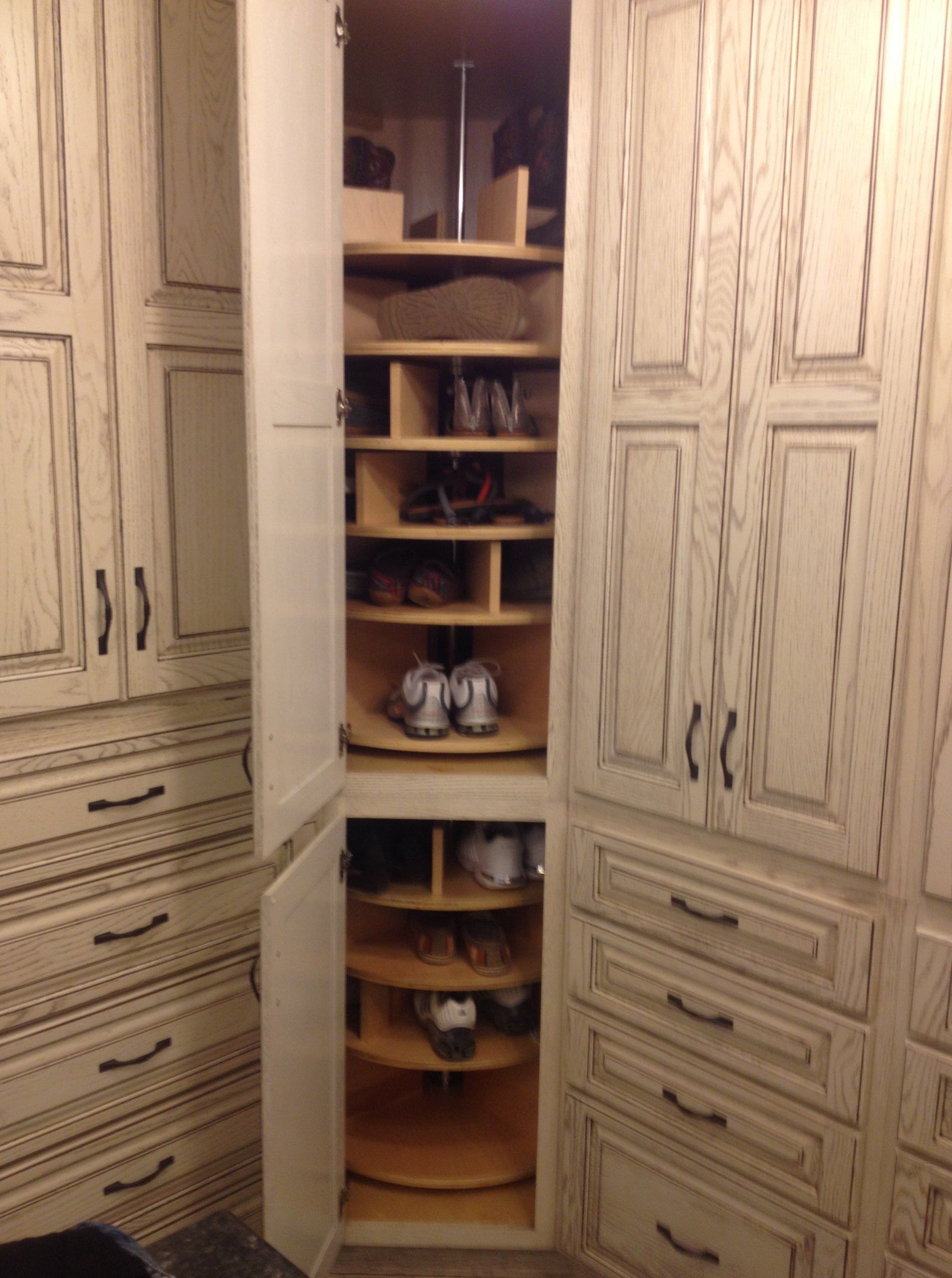 A shoe rack in a closet with the door open