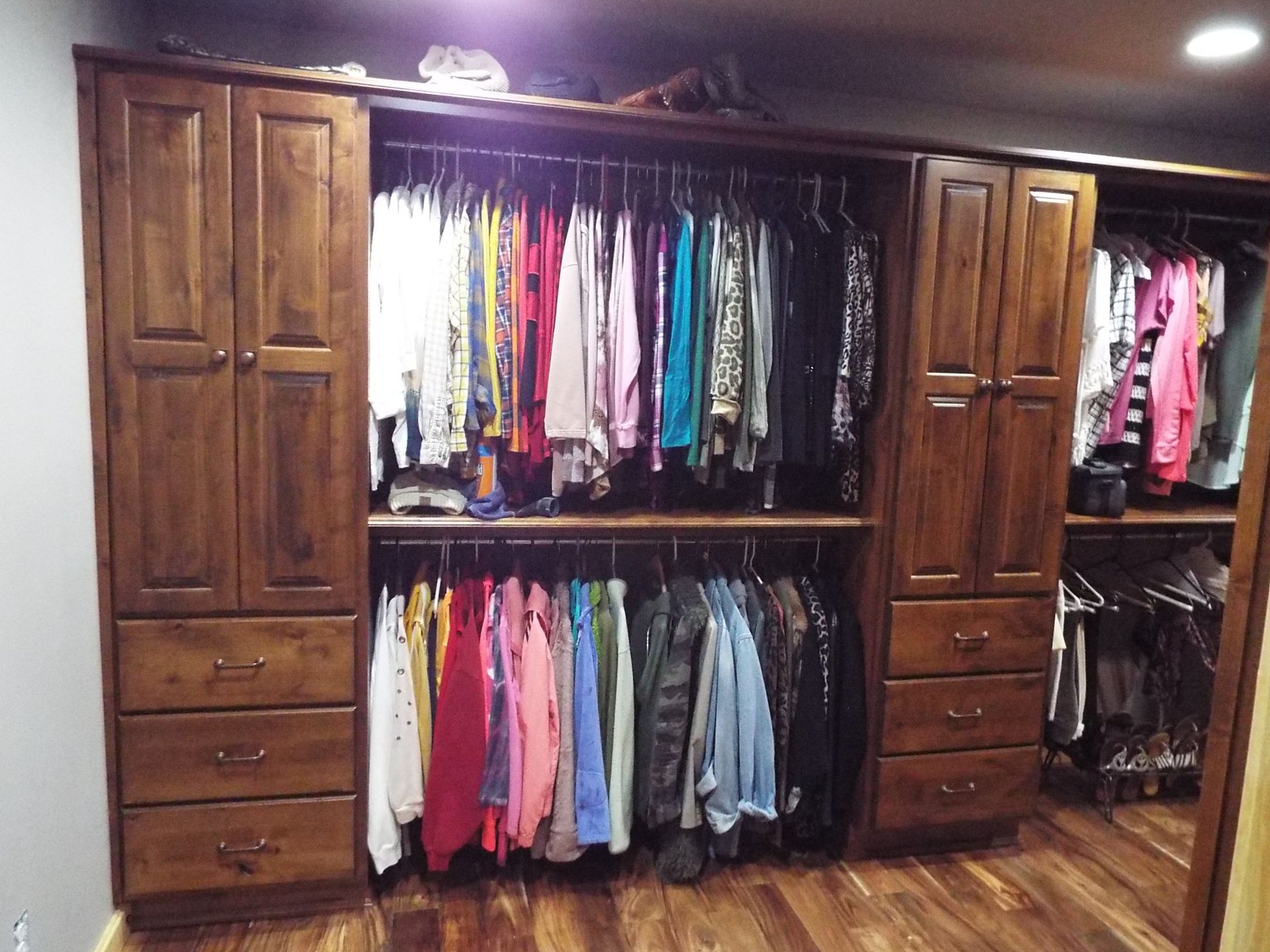 A closet filled with lots of clothes and drawers