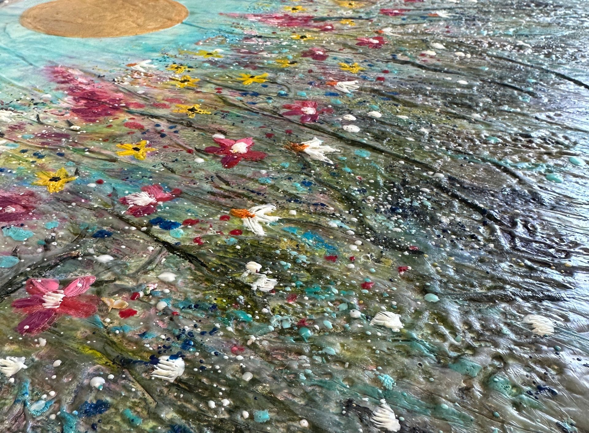 A close up of a painting of flowers on a table.
