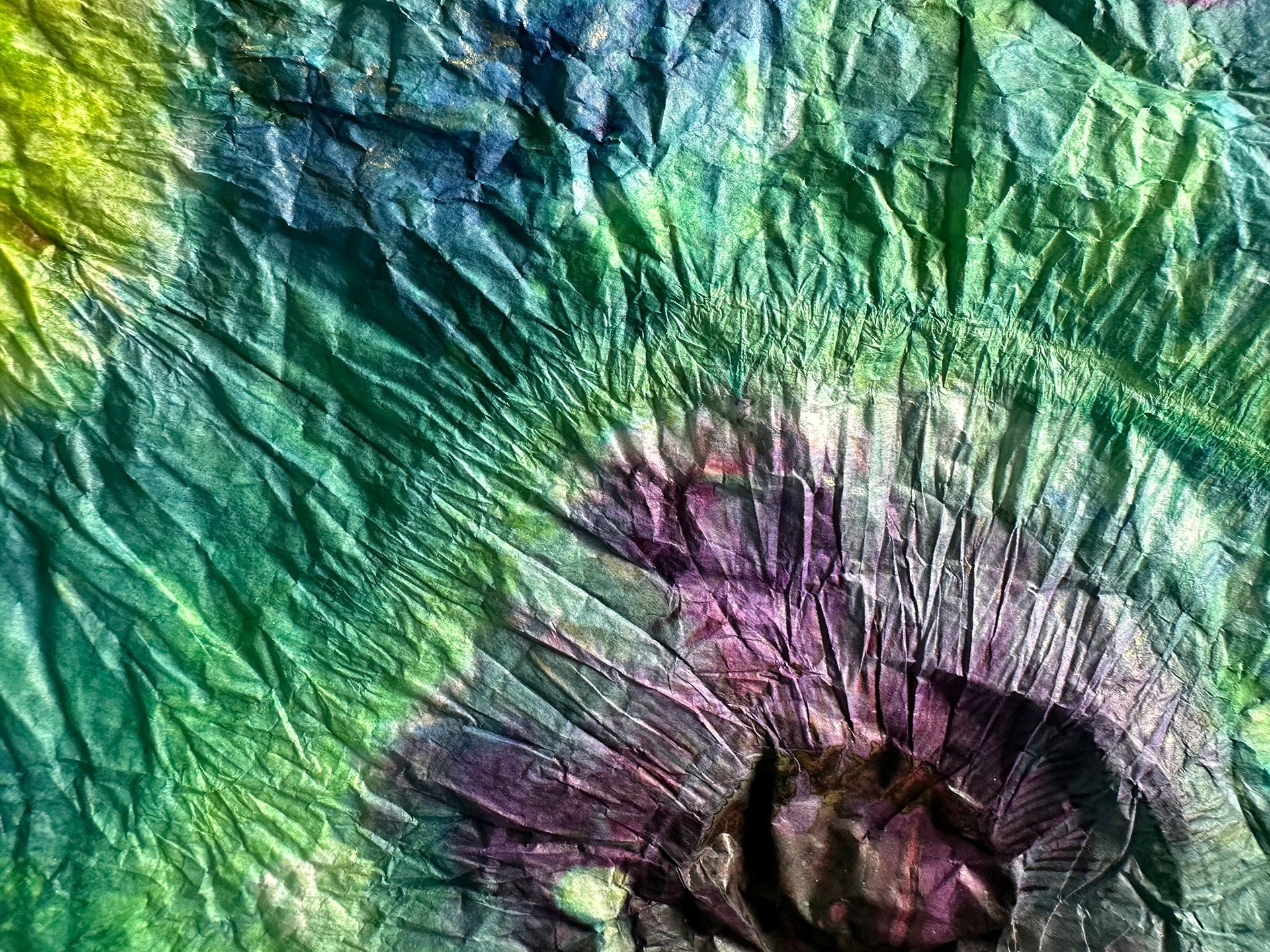 A close up of a colorful tie dye fabric.