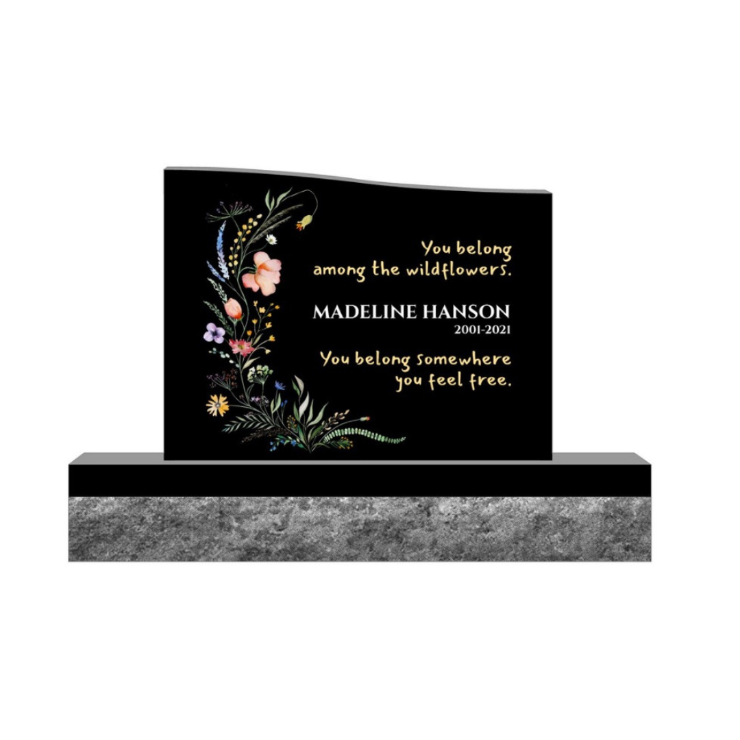 Color laser engraved upright monument featuring flowers.