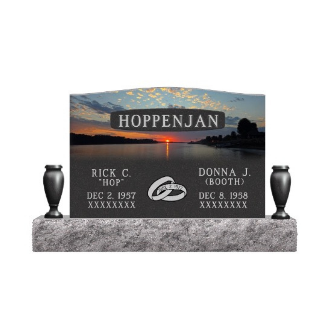 Color laser engraved upright monument featuring a colorful sunset and wedding rings.