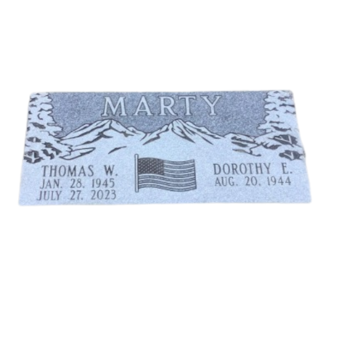 Flat light grey granite companion marker with engravings of trees, mountains, and an American flag.