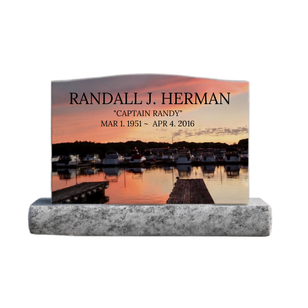 Color laser engraved upright monument featuring a photo of boats in the sunset.