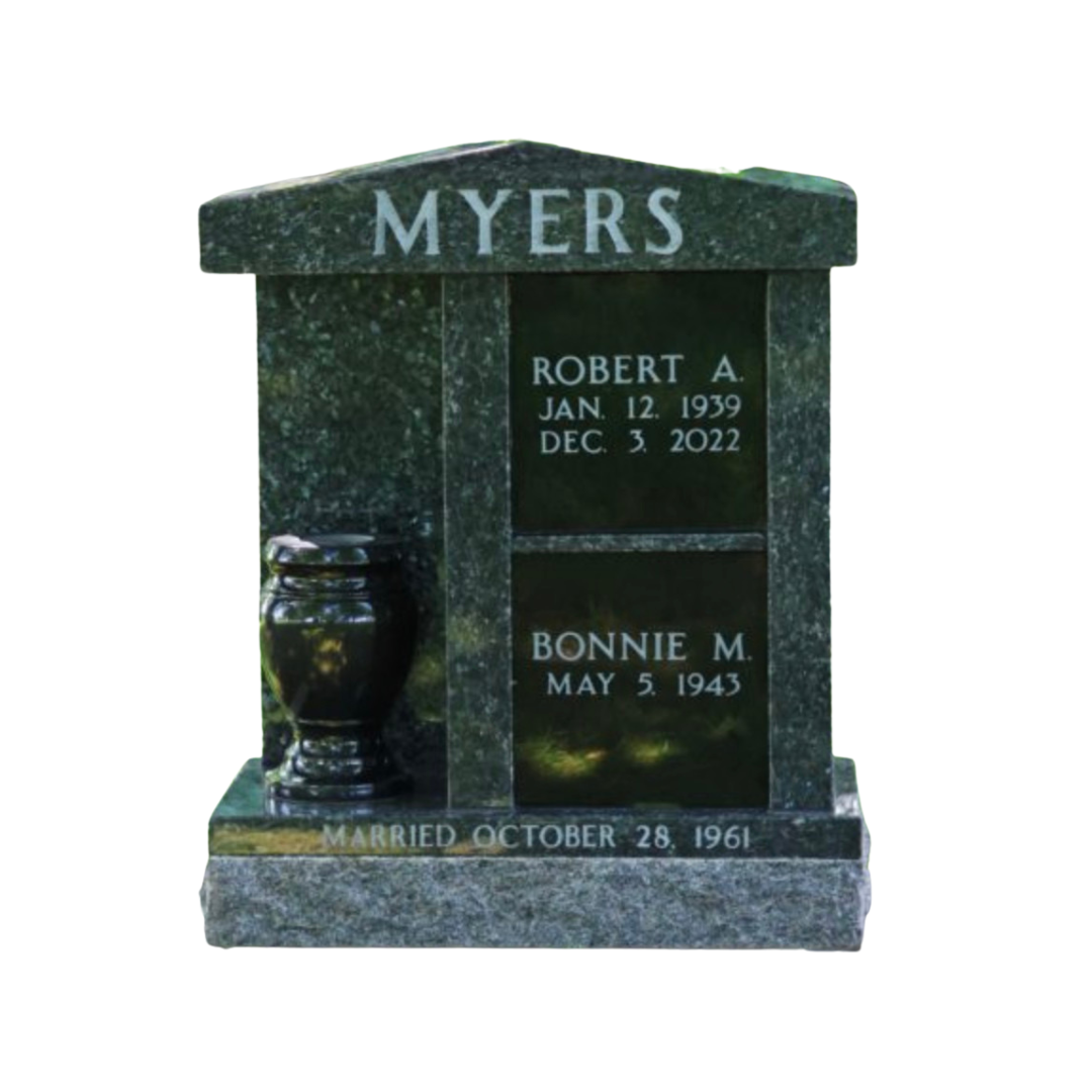 Cremation memorial for two with vertical niches and a vase on one side.