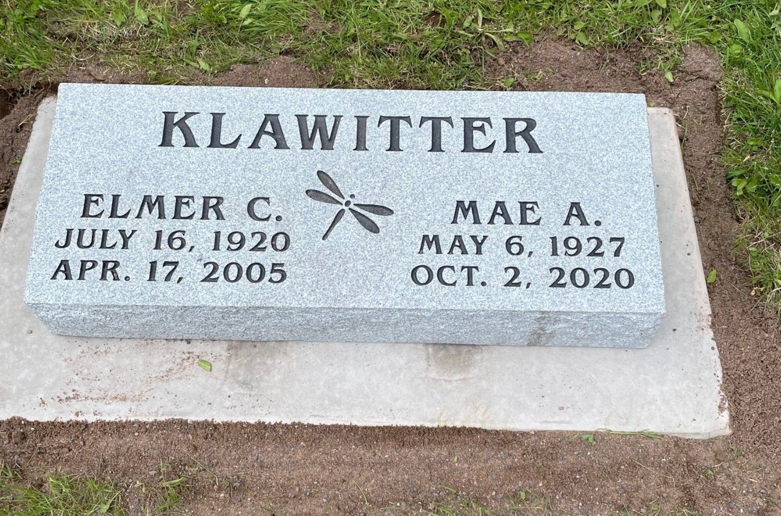 A beveled memorial with the name Klawitter engraved in it. The back edge is about two inches thicker than the front.