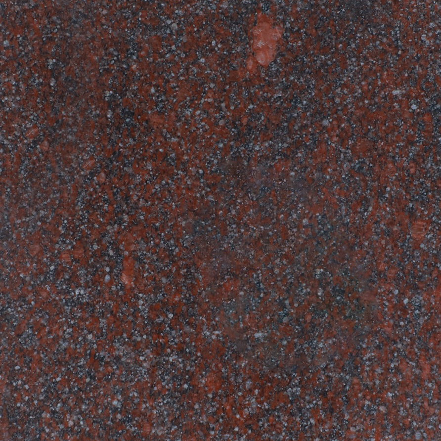 Dar red granite with spots of orange, blue, and black.