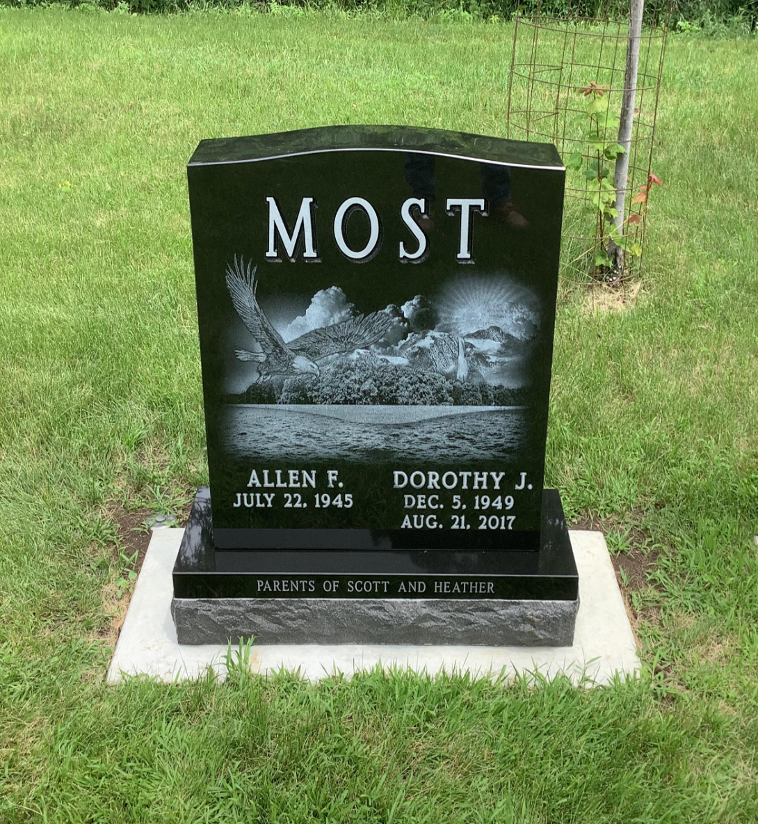 Upright black granite marker bearing the last name Most with laser-engraved image of an eagle.