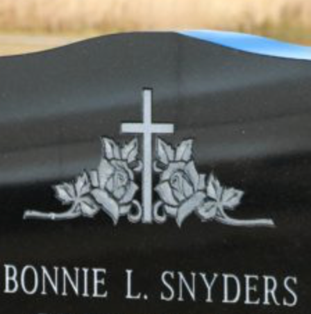 Upright monument with a cross to signify Christian faith.