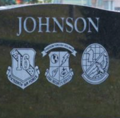 Military symbols on an upright monument.