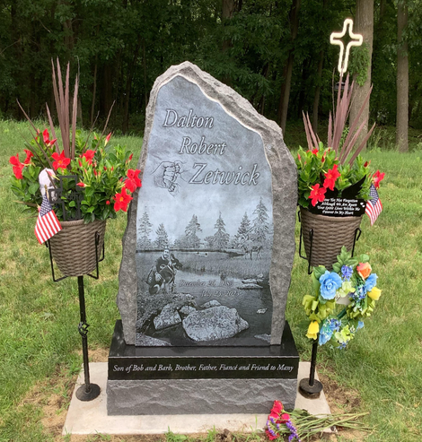 Upright monument with the name Dalton Zetwick engraved on it.  Most components of a memorial can be customized, including the shape of the granite.