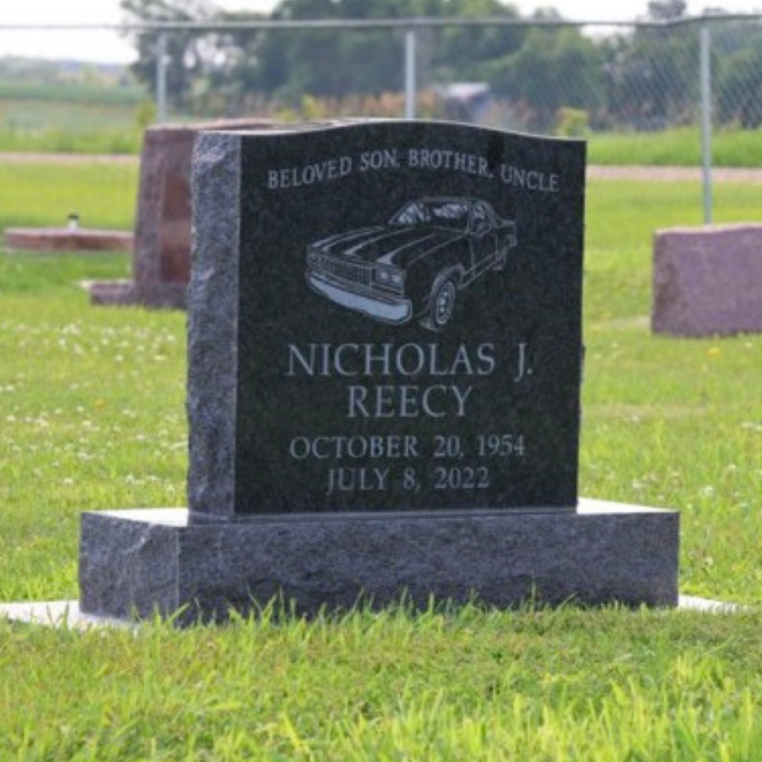 Upright granite monument with the image of a classic car.