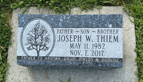 A beveled memorial with the name Joseph Thiem engraved in it. The back edge is about two inches thicker than the front.