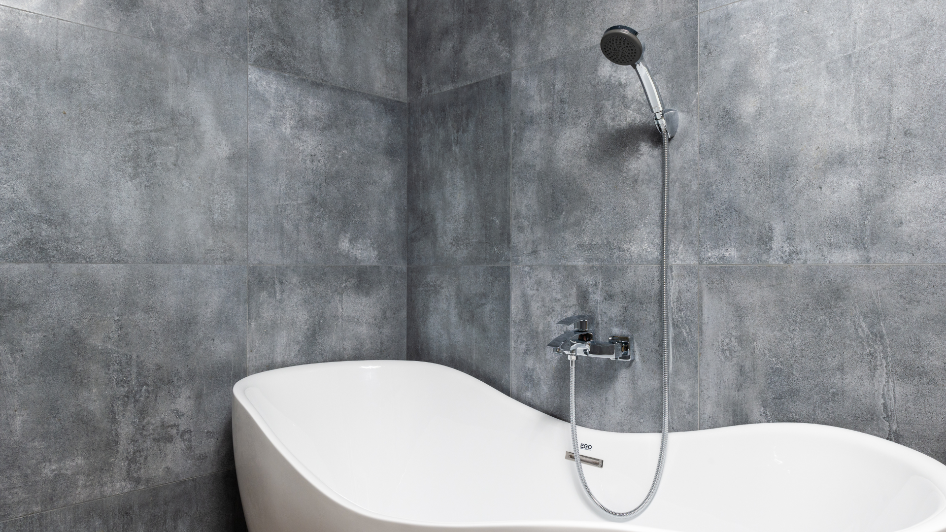 a bathtub with a shower head attached to it in a bathroom .