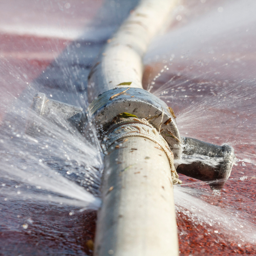 a water pipe is leaking water on the ground .