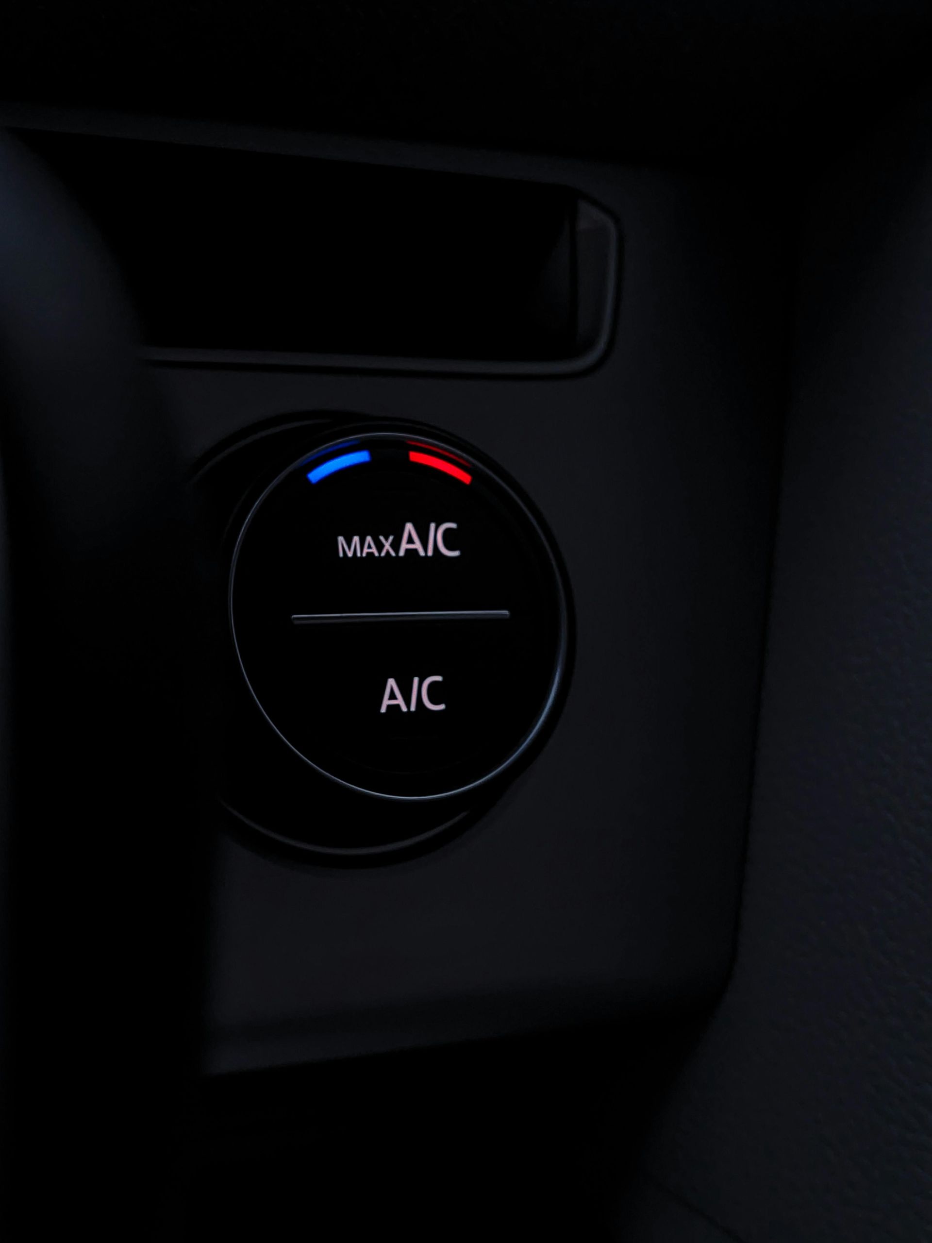 Car air conditioning controls with Max A/C and A/C buttons, blue/red temperature indicators.