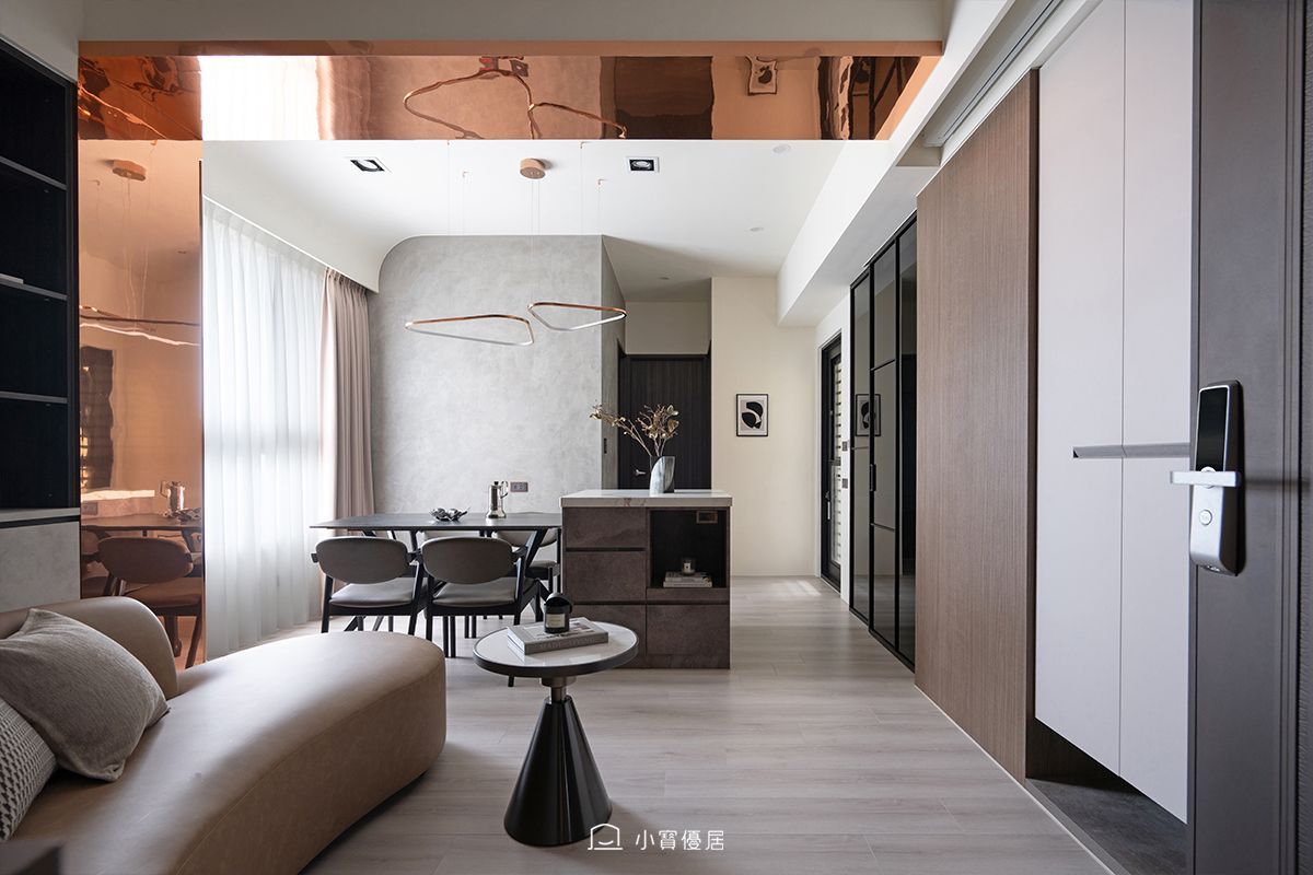 設計團隊將客廳轉向90度，重新整理公共空間，並採用電動投影布幕，增加牆面的運用彈性。