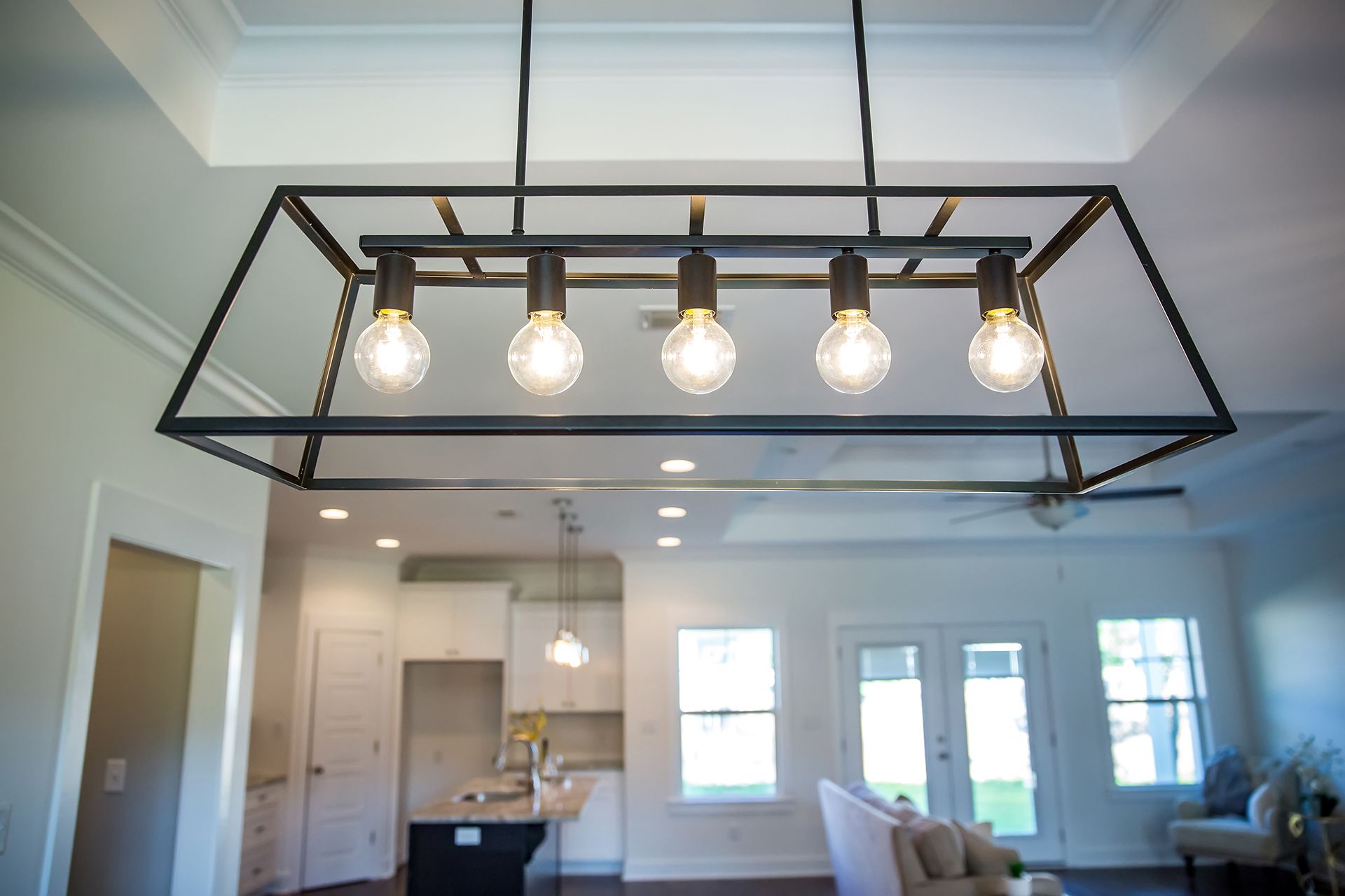 A light fixture is hanging from the ceiling in a living room