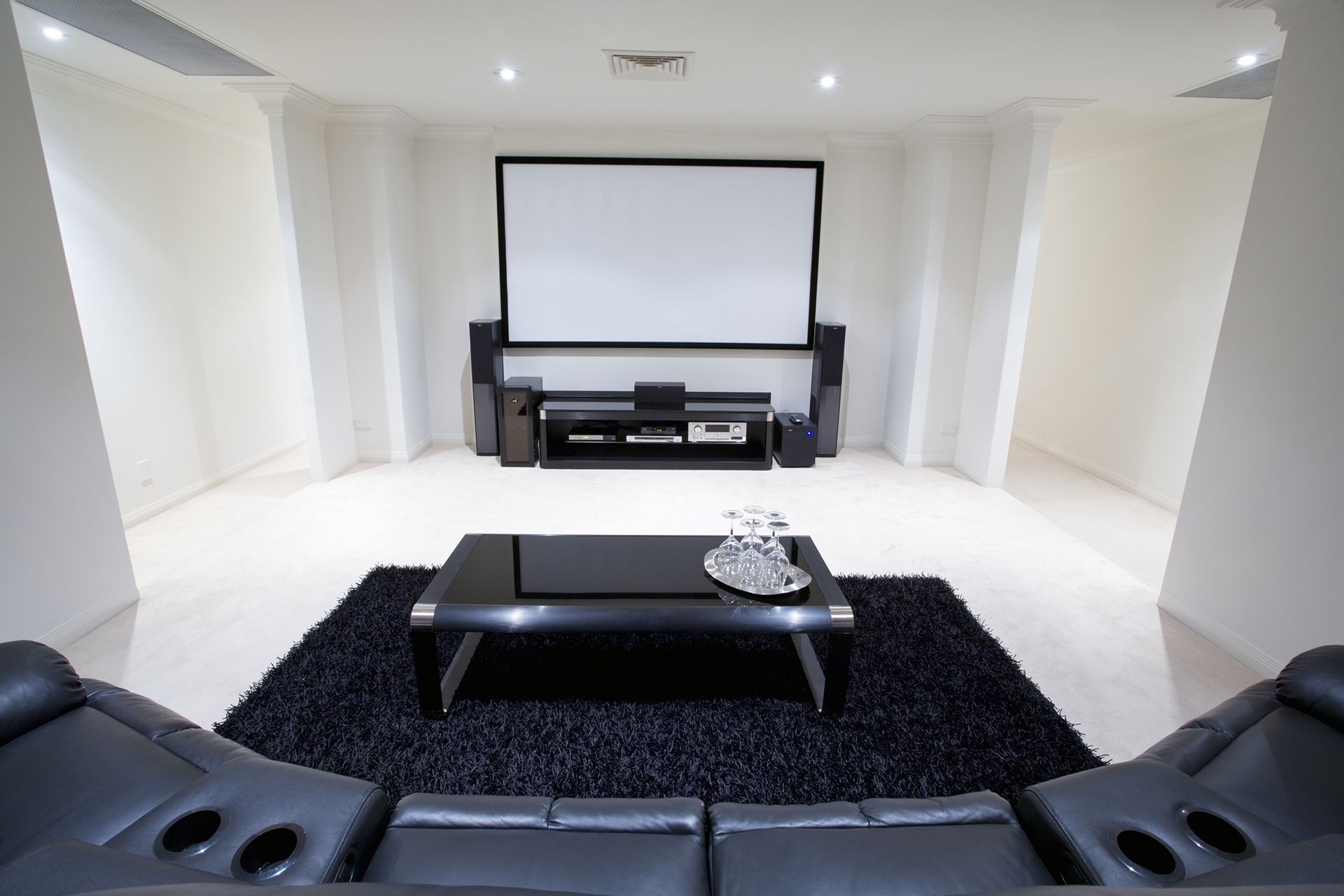 A living room with a projector screen and a couch
