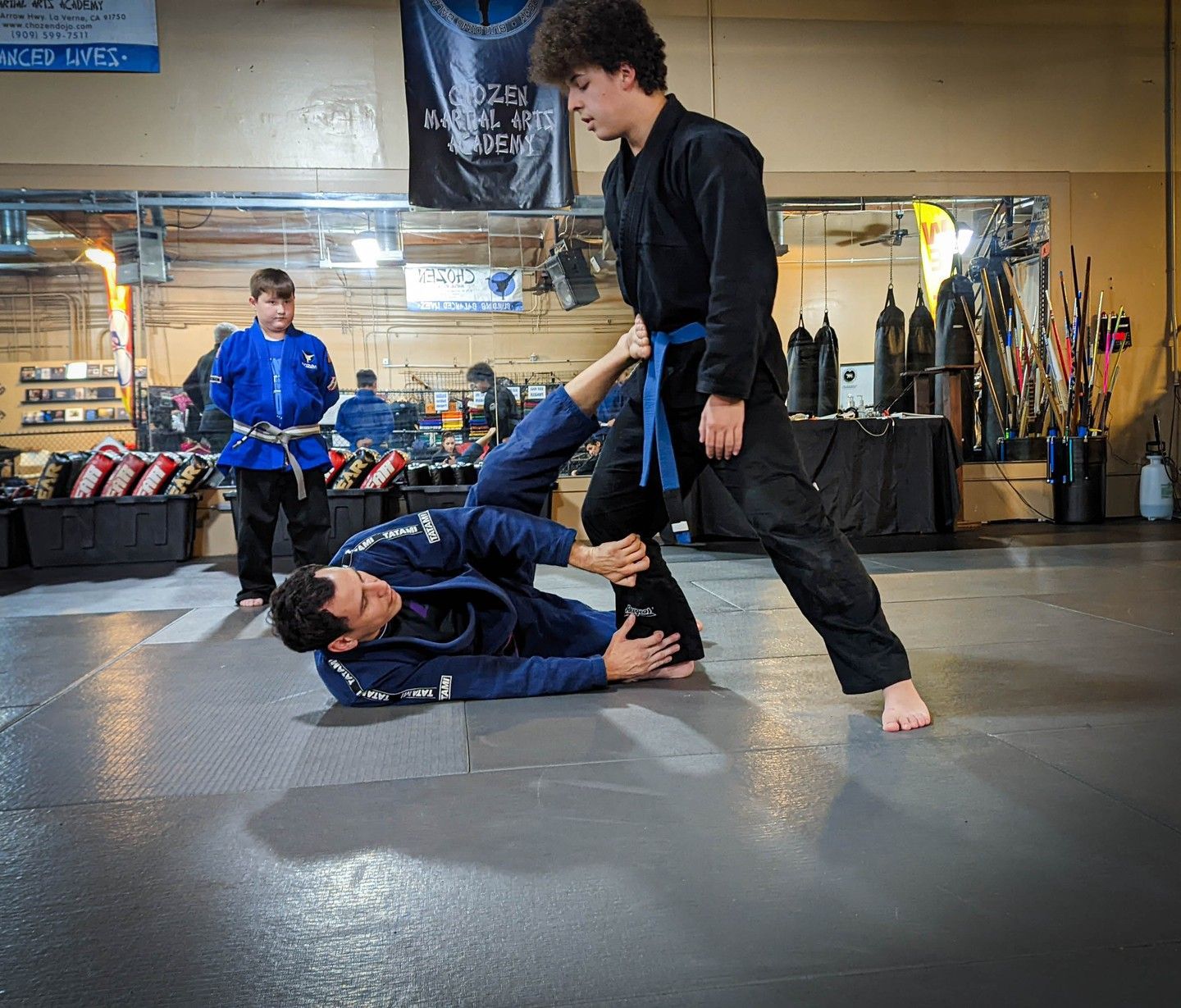 a man and a woman are practicing martial arts on a mat