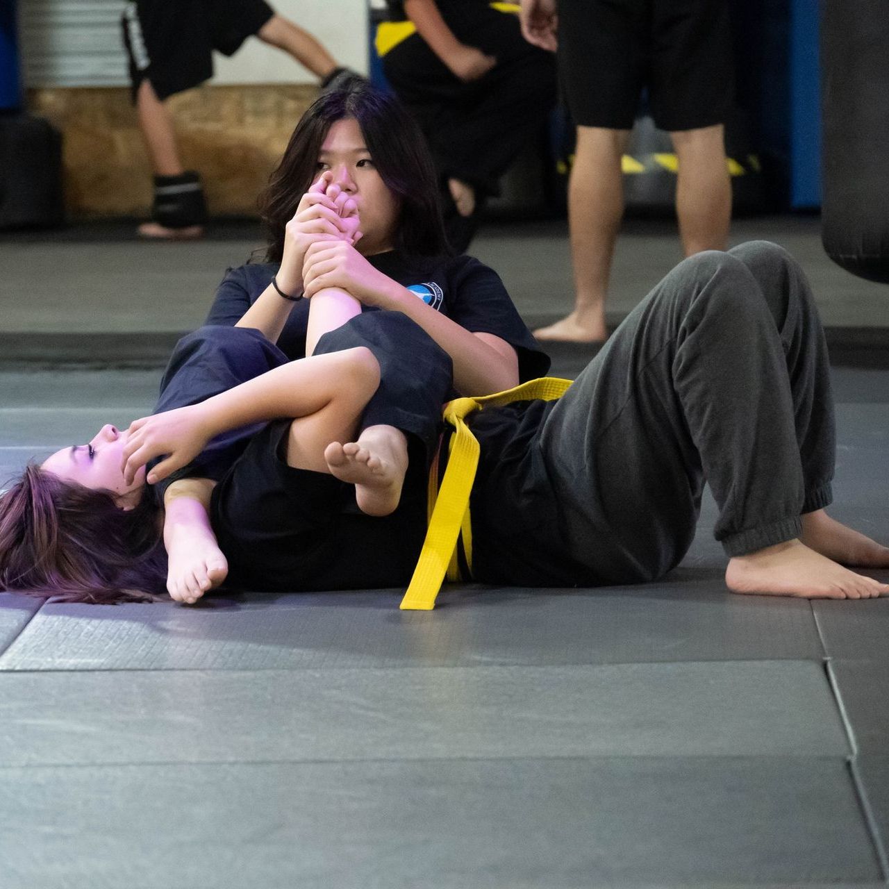 A boy and a girl are practicing taekwondo together.