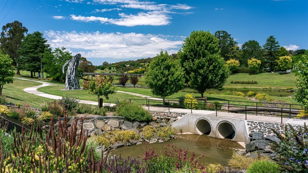 There Is A Bridge Over A Stream In The Middle Of A Park — H2O Plumbing & Maintenance Services In Walcha, NSW