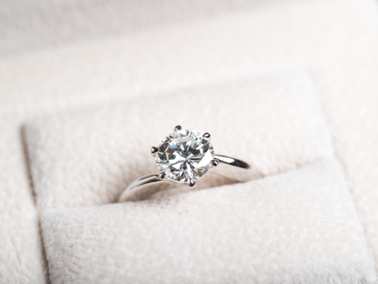 Diamond engagement ring in a white ring box.